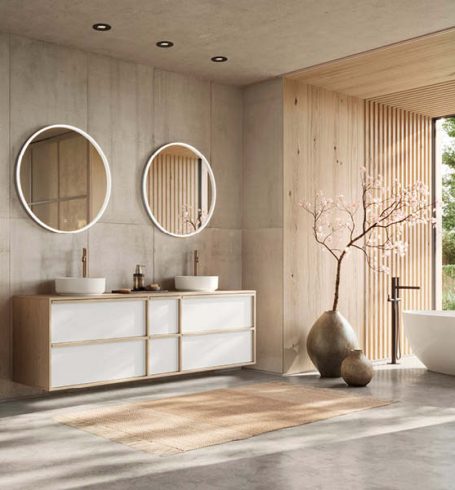 Großzügiges Nobilia Badezimmer mit Doppelwaschtisch in Japandi Stil, runden Spiegeln und viel Stauraum, kombiniert mit natürlichem Licht und klarer Architektur. Durchdachte Badmöbel bei SPECHT.