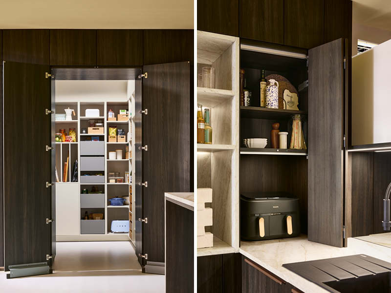 Elegante Küchen von Schüller mit dunklen Holzfronten, verstecktem Stauraum und integriertem Geräteschrank für Vorräte und Küchengeräte.